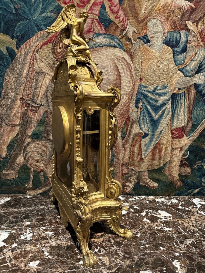 Large pendulum clock in gilt bronze with cut glass 19th century. Representation of Chronos figure , winged Mythological beasts and decorations in bronze working with a suns balance. Richly decorated dial signed R.COTTIN.26 Rue Amelot PARIS