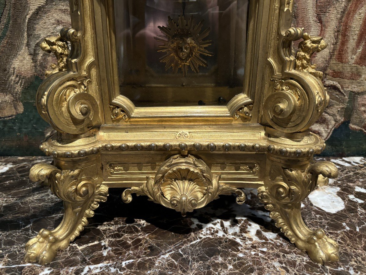 Large pendulum clock in gilt bronze with cut glass 19th century. Representation of Chronos figure , winged Mythological beasts and decorations in bronze working with a suns balance. Richly decorated dial signed R.COTTIN.26 Rue Amelot PARIS