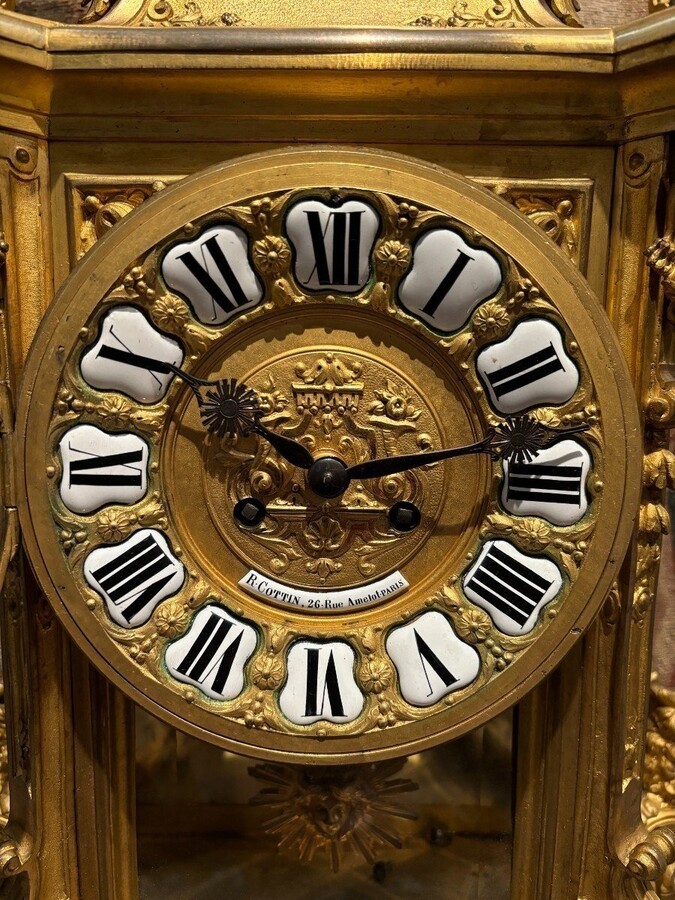 Large pendulum clock in gilt bronze with cut glass 19th century. Representation of Chronos figure , winged Mythological beasts and decorations in bronze working with a suns balance. Richly decorated dial signed R.COTTIN.26 Rue Amelot PARIS