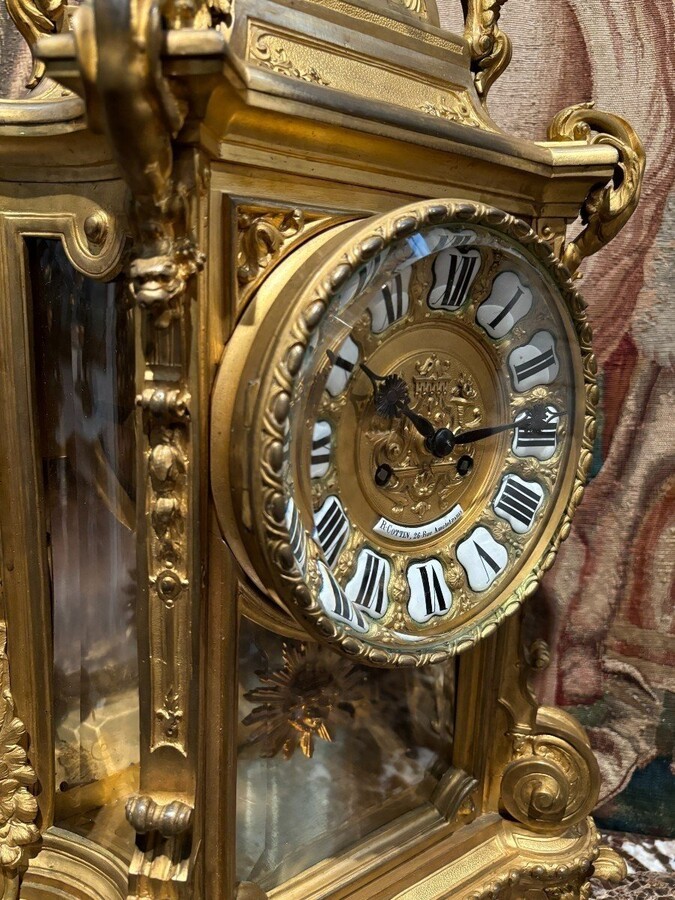 Large pendulum clock in gilt bronze with cut glass 19th century. Representation of Chronos figure , winged Mythological beasts and decorations in bronze working with a suns balance. Richly decorated dial signed R.COTTIN.26 Rue Amelot PARIS