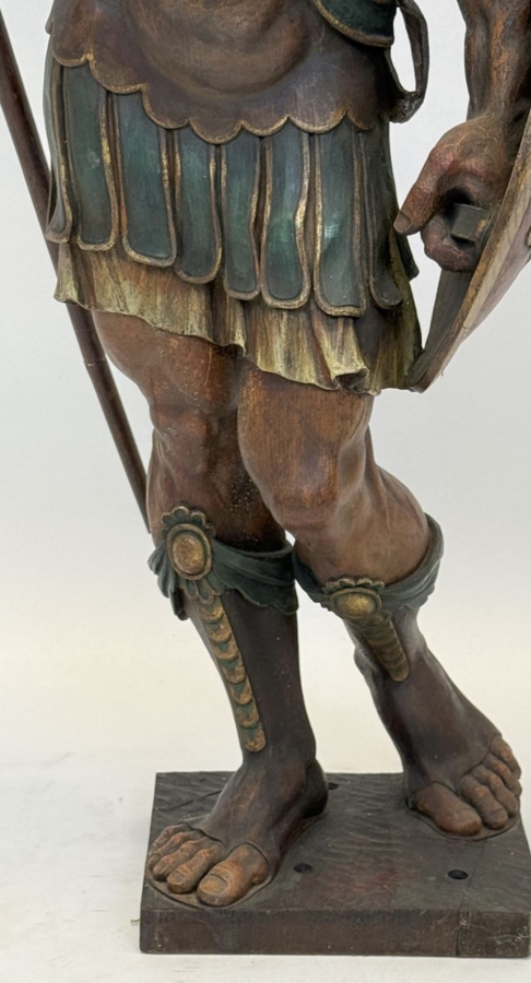 Large polychrome oak sculpture of a soldier/warrior late 19th century   Very decorative and detailed carving of a warrior with shield and spear. In very good condition. Dimensions : Height : 109 / 134 cm  Width : 49 cm Depth : 39 cm Foot : 26 x 21,5 cm Be