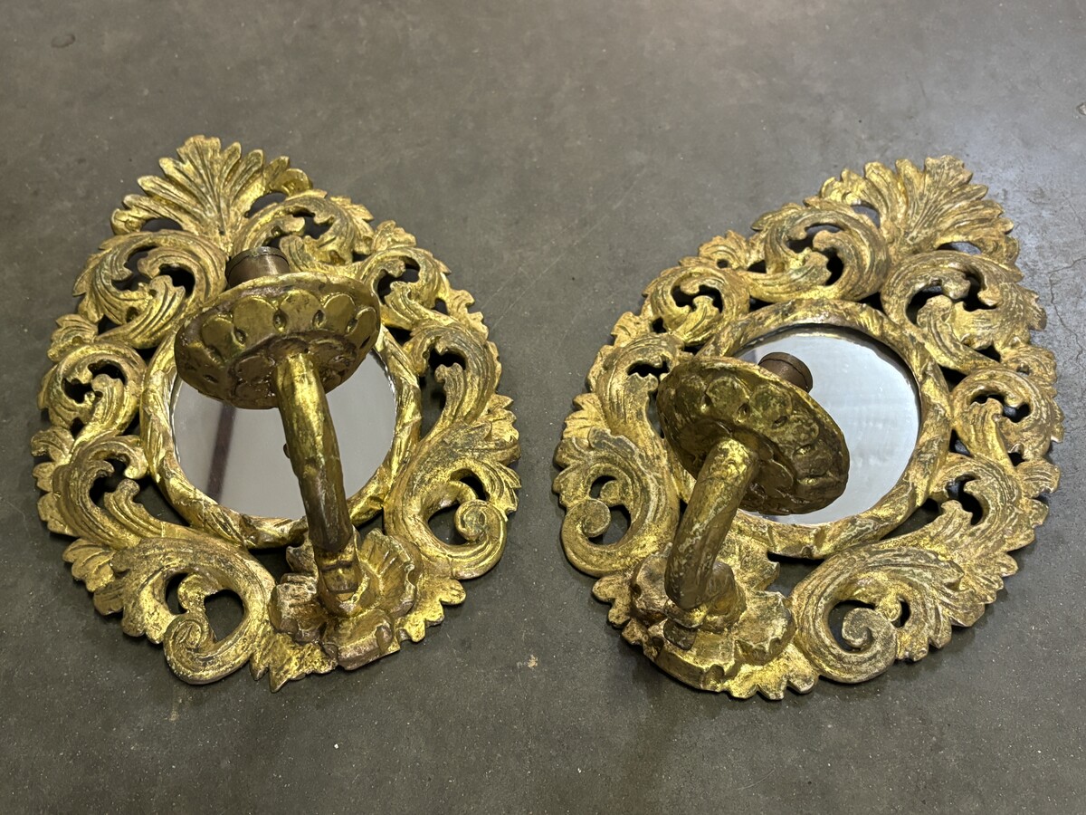 Pair of 19th century gilded wood wall lights with mirror. Pair of decorative sconces in carved wood for candles. Dimensions:  Height : 41 cm Width : 27 cm Depth : 21 cm Both in very good condition, 19th century.