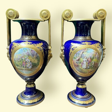 Pair of beautiful Empire style porcelain vases Sèvres , 20th Century Pair of vases with romantic paintings in blue and gilt tones. Signed by G.Etemod and underneath marked with Sèvres sign Dimensions : Height : 55 cm Width : 28 cm Diameter foot : 18 cm In