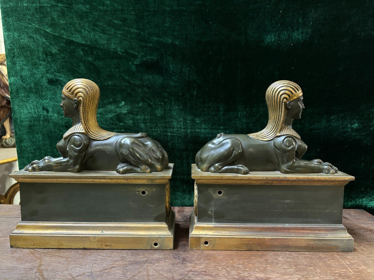 Pair of bronze empire-style sphinxes 19th century Decorative pair of patinated/gilt bronze sphinxes standing on pedestal Parts of chenets are present if desired ( see photo 12 ) Dimensions sphinx on plinth : Height : 30 cm Width : 28 cm Depth : 12 cm 