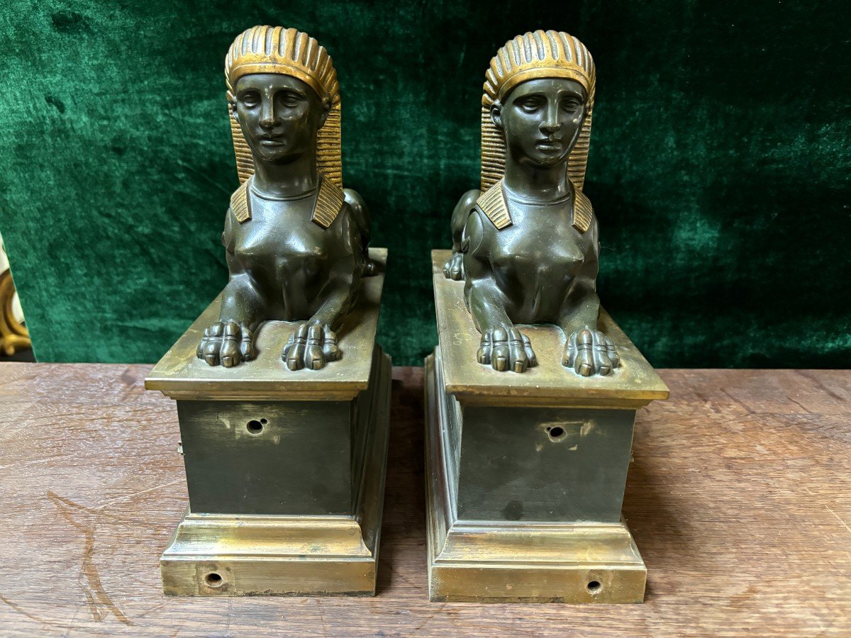 Pair of bronze empire-style sphinxes 19th century Decorative pair of patinated/gilt bronze sphinxes standing on pedestal Parts of chenets are present if desired ( see photo 12 ) Dimensions sphinx on plinth : Height : 30 cm Width : 28 cm Depth : 12 cm 