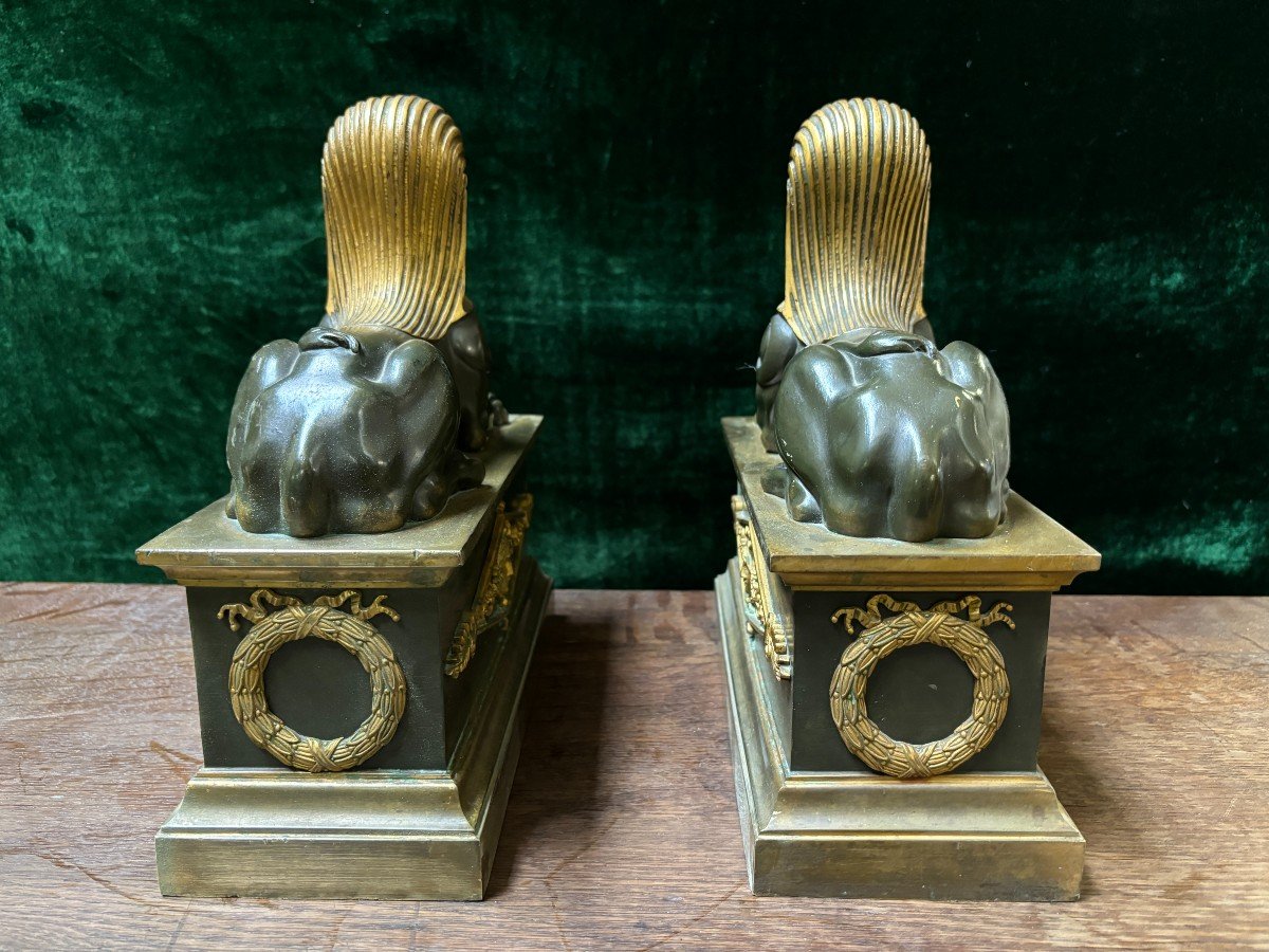 Pair of bronze empire-style sphinxes 19th century Decorative pair of patinated/gilt bronze sphinxes standing on pedestal Parts of chenets are present if desired ( see photo 12 ) Dimensions sphinx on plinth : Height : 30 cm Width : 28 cm Depth : 12 cm 