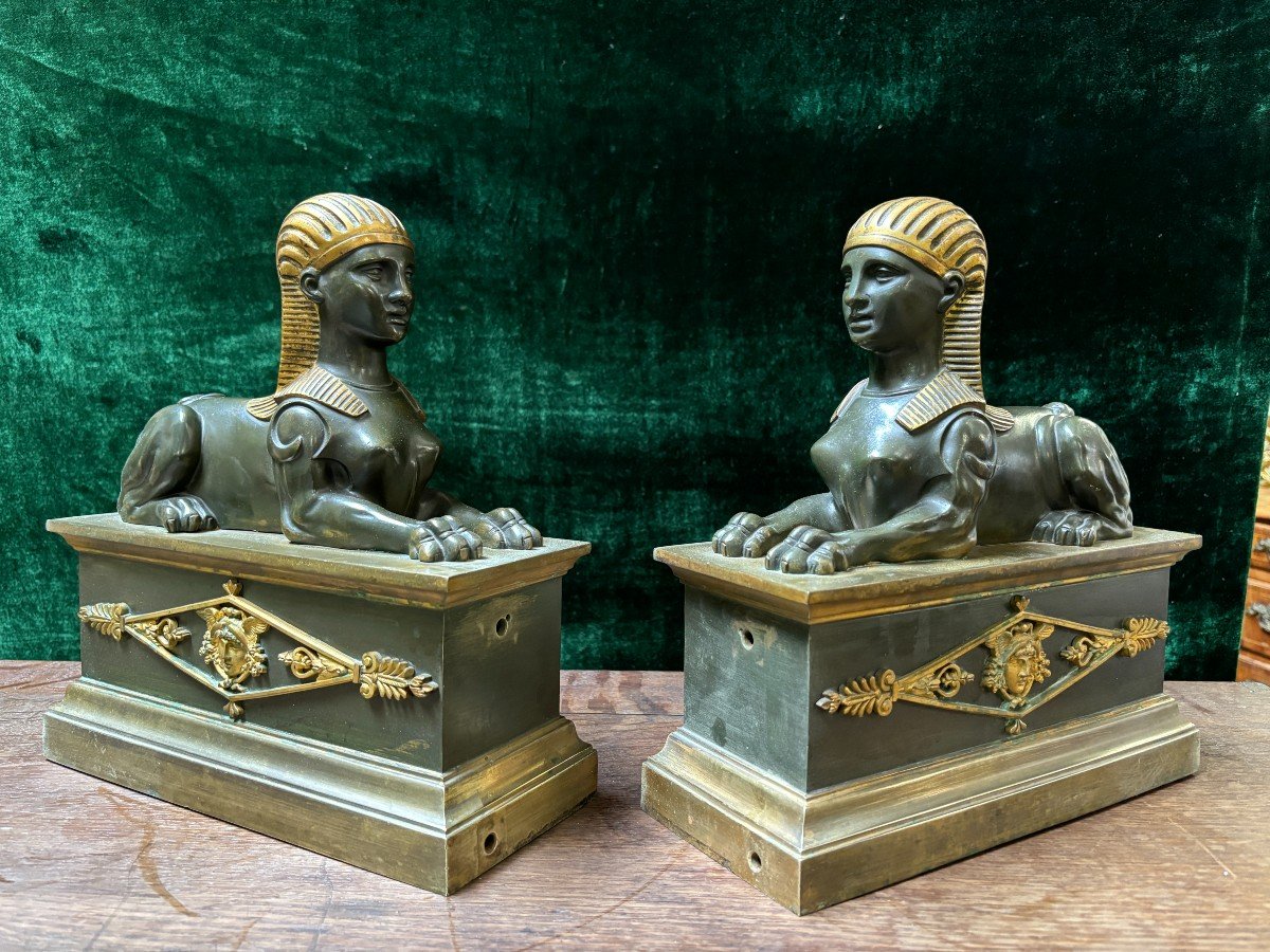 Pair of bronze empire-style sphinxes 19th century Decorative pair of patinated/gilt bronze sphinxes standing on pedestal Parts of chenets are present if desired ( see photo 12 ) Dimensions sphinx on plinth : Height : 30 cm Width : 28 cm Depth : 12 cm 