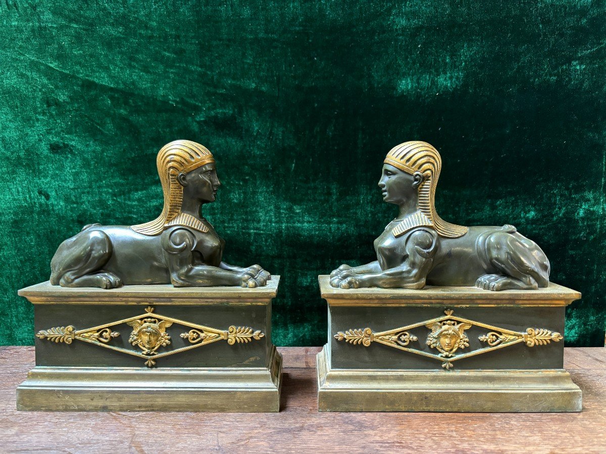 Pair of bronze empire-style sphinxes 19th century Decorative pair of patinated/gilt bronze sphinxes standing on pedestal Parts of chenets are present if desired ( see photo 12 ) Dimensions sphinx on plinth : Height : 30 cm Width : 28 cm Depth : 12 cm 