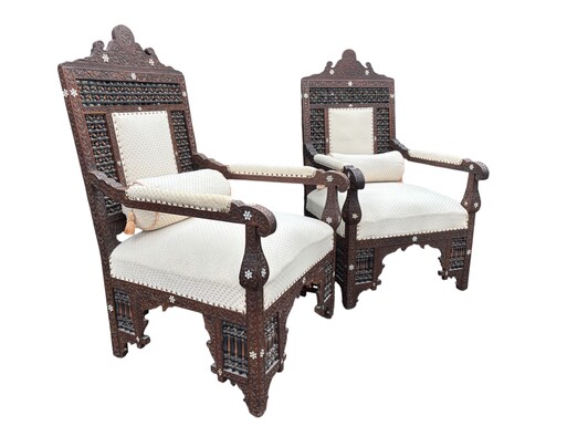 Pair of Carved Armchairs With Ebony And Mother Of Pearl Inlays. Syria, 19th century. Very decorative Orientalist armchairs upholstered in a beautiful fabric with cushion and scroll. Woodwork in good condition with a few chips and inlays due to age.