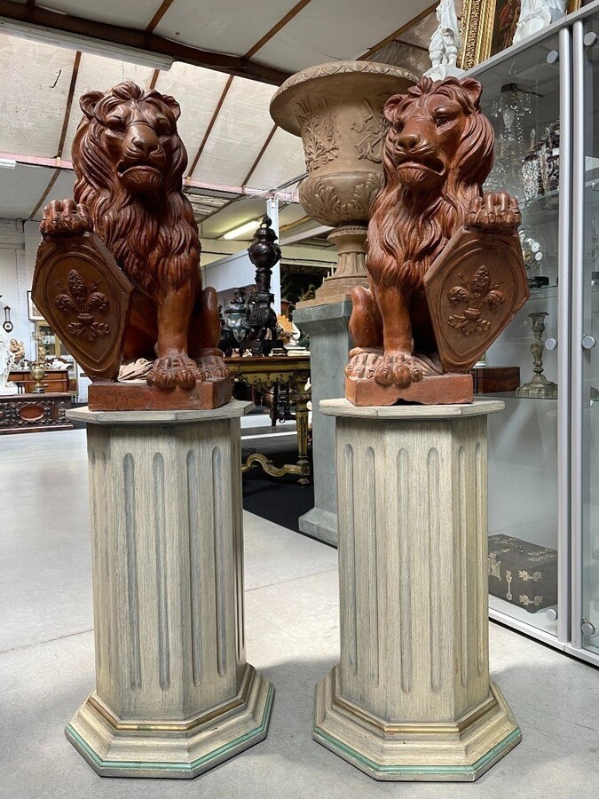 Pair of decorative lions with shields in terra cotta Beautiful pair of lions from Florence Italy from around 1900-1920. Both in good condition with some minor defects.