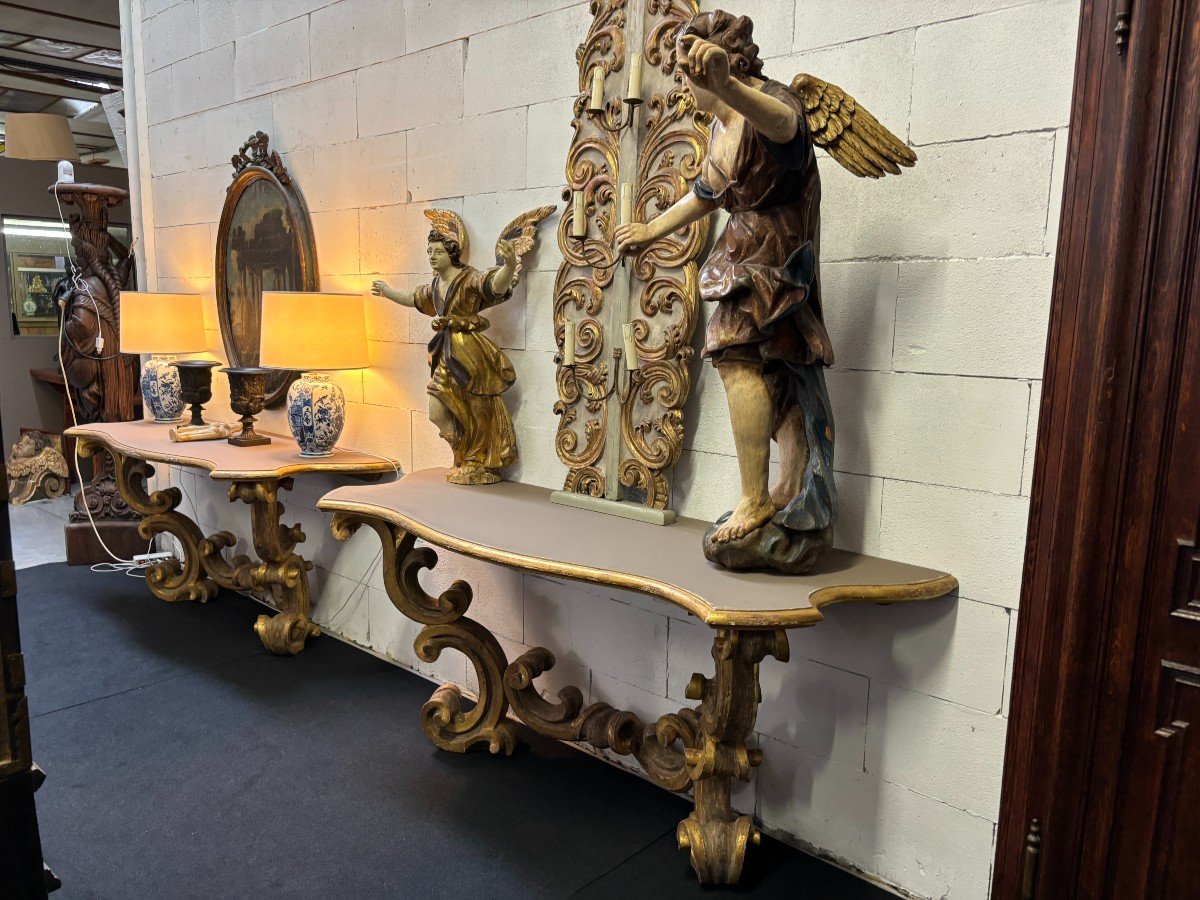 Pair of large consoles in gilt wood , Italian 18th century. Very decorative consoles decorated with large scrolls/ornaments in gilt wood with a painted top (tops in wood are recent , edge of table from the time). Dimensions : Width : 191 cm Height : 83,5