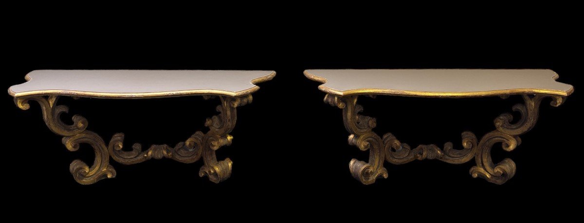 Pair of large consoles in gilt wood , Italian 18th century. Very decorative consoles decorated with large scrolls/ornaments in gilt wood with a painted top (tops in wood are recent , edge of table from the time). Dimensions : Width : 191 cm Height : 83,5