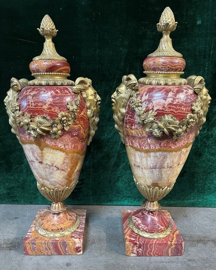 Pair of large marble cassolettes, beautifully coloured 19th century. Very decorative marble cassolettes, decorated with mythological faces and floral gyrations, resting on a marble base with bronze ornaments. Both in very good condition.