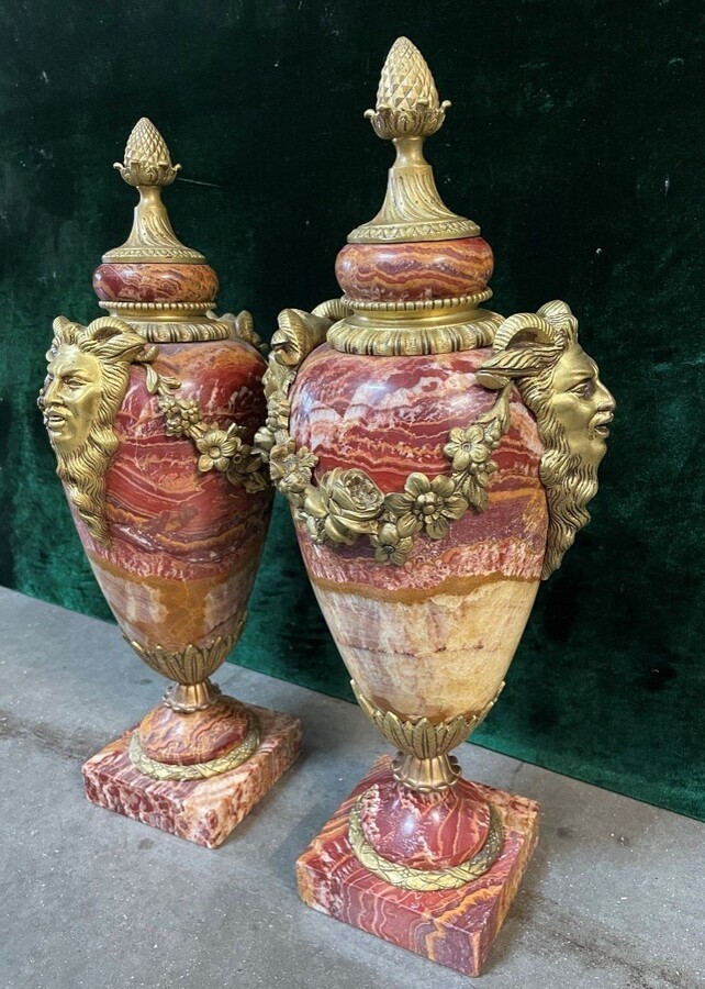 Pair of large marble cassolettes, beautifully coloured 19th century. Very decorative marble cassolettes, decorated with mythological faces and floral gyrations, resting on a marble base with bronze ornaments. Both in very good condition.