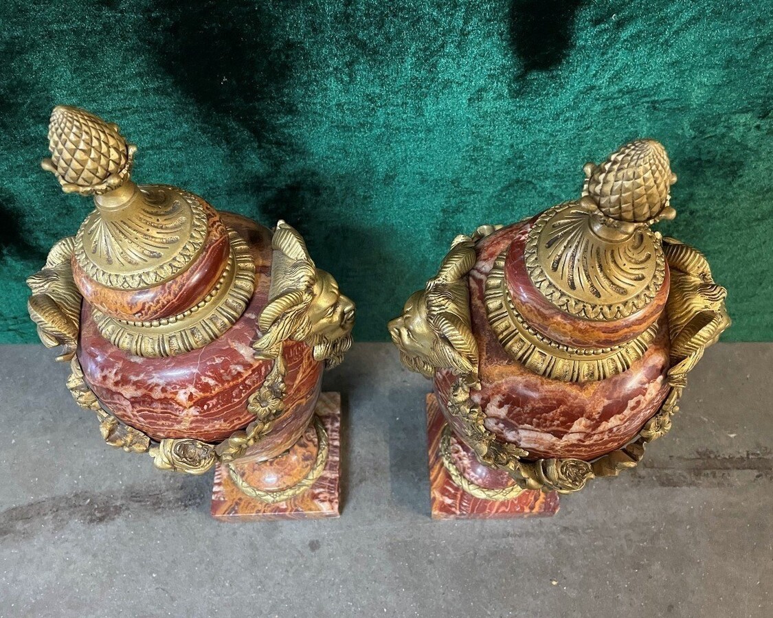 Pair of large marble cassolettes, beautifully coloured 19th century. Very decorative marble cassolettes, decorated with mythological faces and floral gyrations, resting on a marble base with bronze ornaments. Both in very good condition.