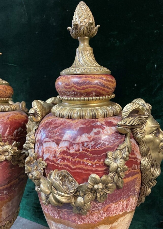 Pair of large marble cassolettes, beautifully coloured 19th century. Very decorative marble cassolettes, decorated with mythological faces and floral gyrations, resting on a marble base with bronze ornaments. Both in very good condition.