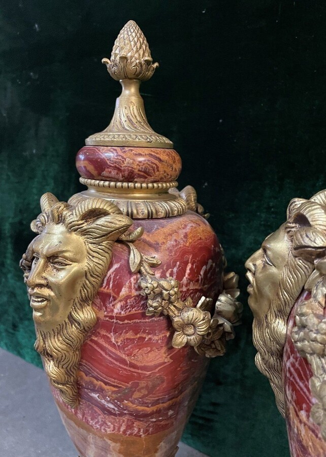 Pair of large marble cassolettes, beautifully coloured 19th century. Very decorative marble cassolettes, decorated with mythological faces and floral gyrations, resting on a marble base with bronze ornaments. Both in very good condition.