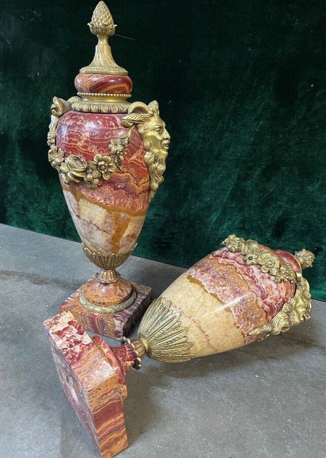 Pair of large marble cassolettes, beautifully coloured 19th century. Very decorative marble cassolettes, decorated with mythological faces and floral gyrations, resting on a marble base with bronze ornaments. Both in very good condition.