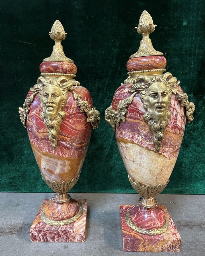 Pair of large marble cassolettes, beautifully coloured 19th century. Very decorative marble cassolettes, decorated with mythological faces and floral gyrations, resting on a marble base with bronze ornaments. Both in very good condition.