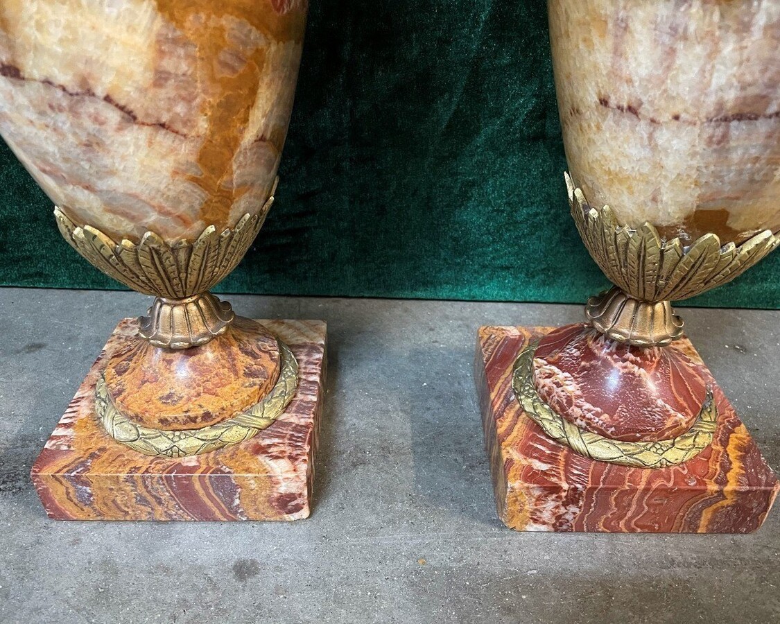 Pair of large marble cassolettes, beautifully coloured 19th century. Very decorative marble cassolettes, decorated with mythological faces and floral gyrations, resting on a marble base with bronze ornaments. Both in very good condition.