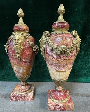 Pair of large marble cassolettes, beautifully coloured 19th century. Very decorative marble cassolettes, decorated with mythological faces and floral gyrations, resting on a marble base with bronze ornaments. Both in very good condition.