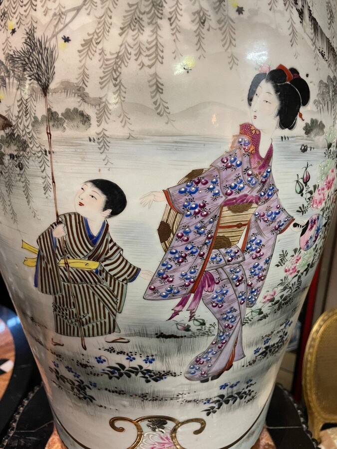 Pair of large porcelain vases Japan early 20th century ( 62 cm ). Vases in coloured porcelain with images of characters, ornaments, water and flora. Both are in very good condition with the following dimensions: Height: 62 cm Width: 34 cm