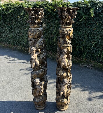 Pair of large turned columns with capitals 17th century. Very decorative polychrome oak columns from the Baroque period decorated with grapevines , birds, per column 2 putti and on top a corinthian capital The columns have some missing parts