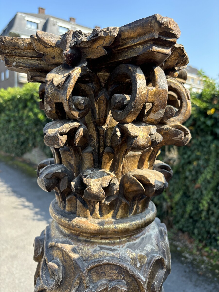 Pair of large turned columns with capitals 17th century. Very decorative polychrome oak columns from the Baroque period decorated with grapevines , birds, per column 2 putti and on top a corinthian capital The columns have some missing parts