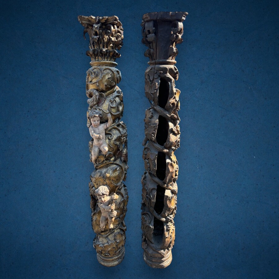 Pair of large turned columns with capitals 17th century. Very decorative polychrome oak columns from the Baroque period decorated with grapevines , birds, per column 2 putti and on top a corinthian capital The columns have some missing parts