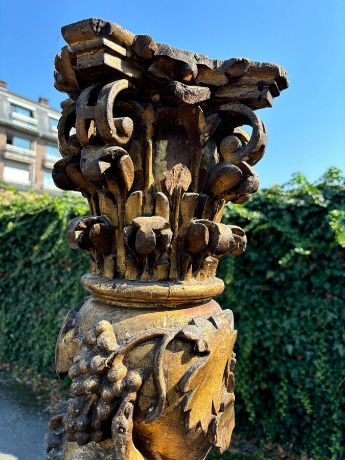  Pair of large turned columns with capitals 17th century. Very decorative polychrome oak columns from the Baroque period decorated with grapevines , birds, per column 2 putti and on top a corinthian capital The columns have some missing parts