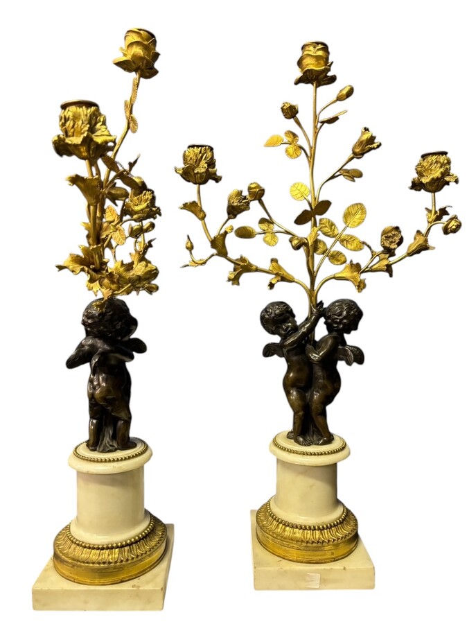 Pair of Napoleon III ‘2 angels’ bronze candelabras. Nice 19thC. candelabra representing a pair of angels carrying 3 gilt bronze candelabra with sprigs of flowers resting on a white marble base.