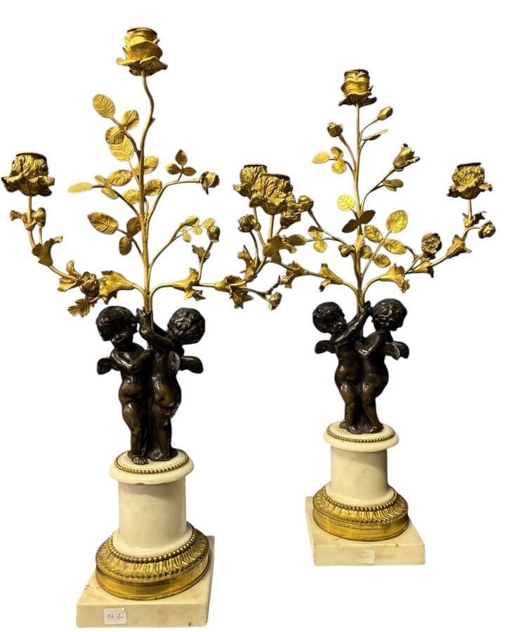 Pair of Napoleon III ‘2 angels’ bronze candelabras. Nice 19thC. candelabra representing a pair of angels carrying 3 gilt bronze candelabra with sprigs of flowers resting on a white marble base.