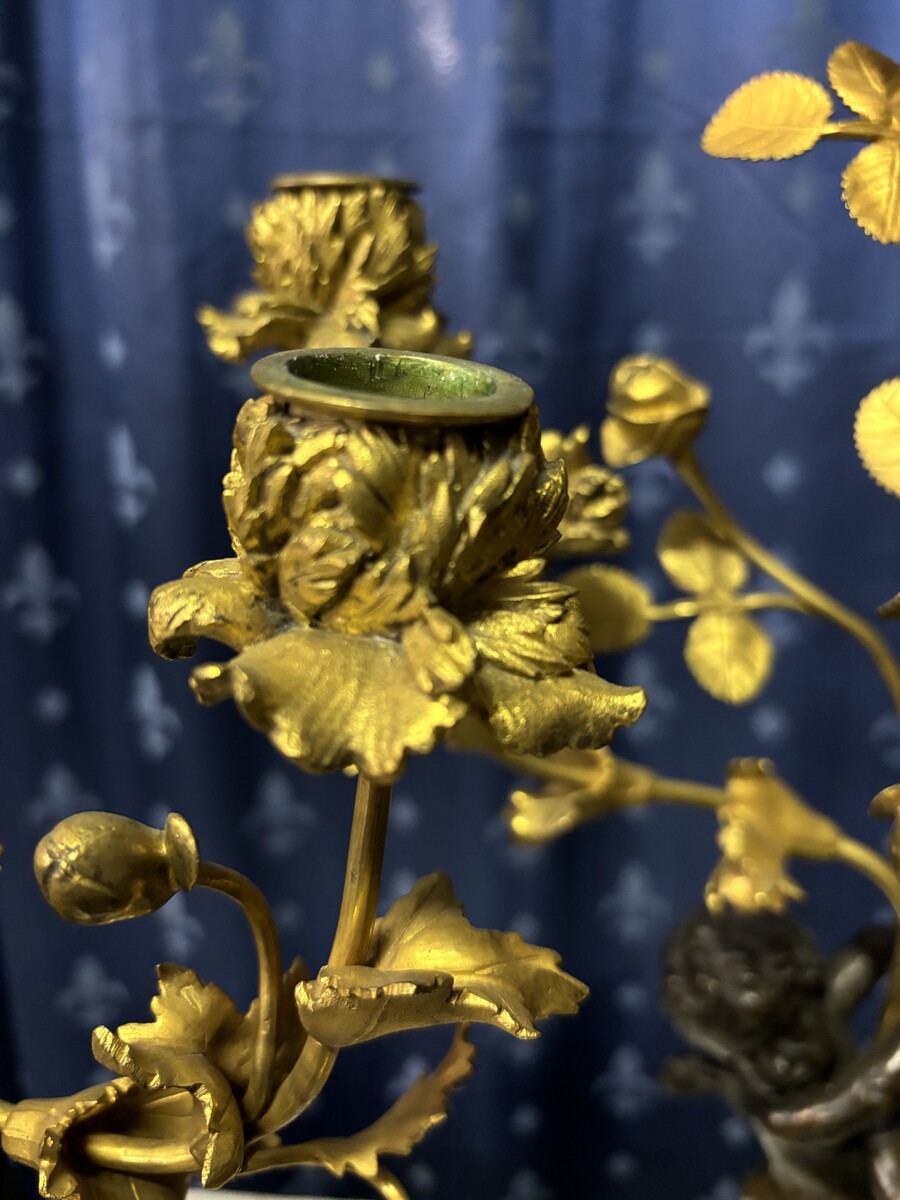 Pair of Napoleon III ‘2 angels’ bronze candelabras. Nice 19thC. candelabra representing a pair of angels carrying 3 gilt bronze candelabra with sprigs of flowers resting on a white marble base.