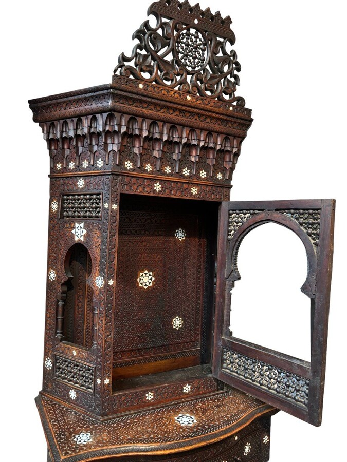 Sculpted furniture with inlays of ebony and mother-of-pearl. Syria , early 19th century. Furniture in used condition , consists of 2 parts with some missing pieces of wood Dimensions : Height : 234 cm Width : 86 cm Depth : 30 / 48 cm