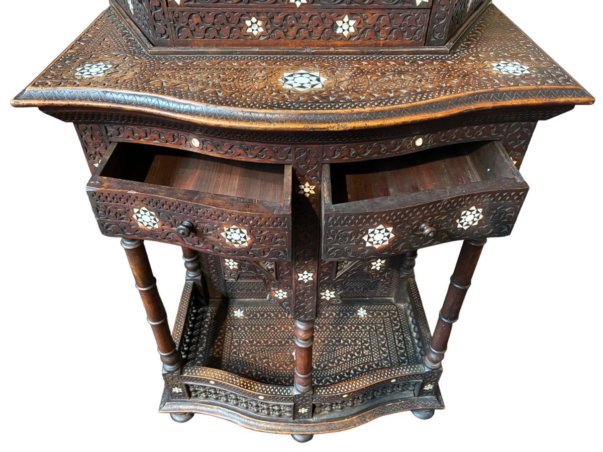 Sculpted furniture with inlays of ebony and mother-of-pearl. Syria , early 19th century. Furniture in used condition , consists of 2 parts with some missing pieces of wood Dimensions : Height : 234 cm Width : 86 cm Depth : 30 / 48 cm