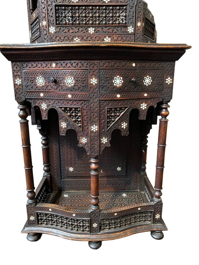 Sculpted furniture with inlays of ebony and mother-of-pearl. Syria , early 19th century. Furniture in used condition , consists of 2 parts with some missing pieces of wood Dimensions : Height : 234 cm Width : 86 cm Depth : 30 / 48 cm