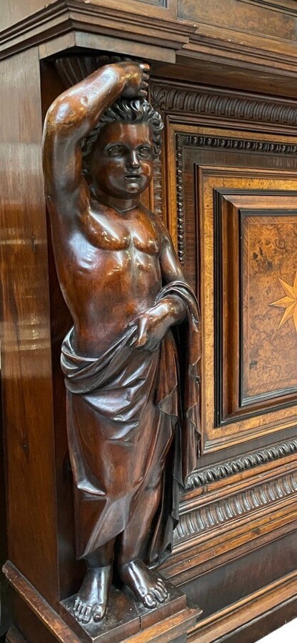 Special cabinet with 2 large sculptures in walnut 19th century. Beautiful cabinet with a distinct shape ( corner ) fitted with 2 doors and 2 drawers , 2 finely carved sculptures and inlaid marquetry in the doors. Locks in the drawers are missing.