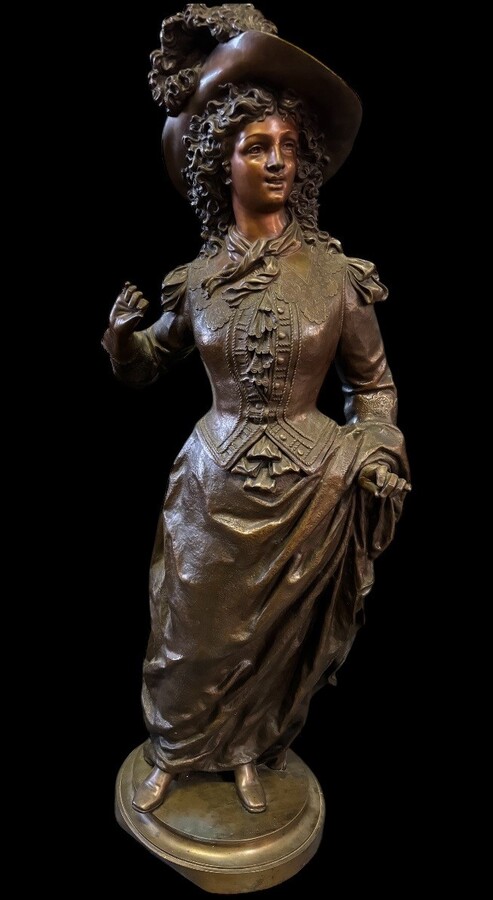 Very large bronze sculpture ‘noble lady ’ 19th century ( 103 cm ). Elegant sculpture of a noble lady with feather hat, signed by Ernest Rancoulet ( French 1870-1915 ). In good condition, with a dent in the base. 